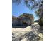 Backyard of home with a patio and balcony above. Mature trees with a driveway at 539 Libby Rd, Babson Park, FL 33827