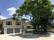 Charming two-story home with a well-manicured lawn, lush landscaping, and a two-car garage at 539 Libby Rd, Babson Park, FL 33827