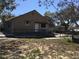 Exterior of house with lawn with patchy grass and mature trees at 539 Libby Rd, Babson Park, FL 33827