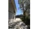 The side exterior of a home with a long driveway, mature trees, and a well-maintained yard at 539 Libby Rd, Babson Park, FL 33827