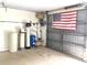 Garage containing a water treatment system and an American flag at 539 Libby Rd, Babson Park, FL 33827