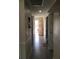 Inviting hallway featuring tile flooring, neutral walls, and natural light streaming through an open door at 539 Libby Rd, Babson Park, FL 33827