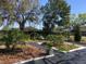 Landscaped yard features garden beds bordered by white concrete and black weed control matting at 539 Libby Rd, Babson Park, FL 33827