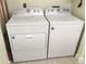 Convenient laundry room with side by side, white washer and dryer units for efficient home chores at 539 Libby Rd, Babson Park, FL 33827