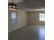 Spacious living room features modern lighting and neutral tile flooring, blending comfort and style at 539 Libby Rd, Babson Park, FL 33827