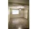 Bright, neutral living room features tile floors, a window and modern light fixture at 539 Libby Rd, Babson Park, FL 33827
