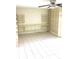 Bright living room features neutral walls, tile floors, built-in shelving, and a ceiling fan at 539 Libby Rd, Babson Park, FL 33827