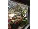 View from the window of backyard with patio set and lush green trees at 539 Libby Rd, Babson Park, FL 33827
