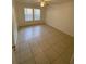 Bedroom featuring tiled floor and natural light from the windows at 5968 Westgate Dr # 101, Orlando, FL 32835