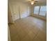 Bright bedroom featuring tiled floor, a ceiling fan, and natural light from the windows at 5968 Westgate Dr # 101, Orlando, FL 32835