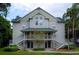 Inviting two-story condo with dual entry stairs, verdant landscaping, and an attractive, neutral-toned facade at 5968 Westgate Dr # 101, Orlando, FL 32835