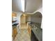 Open-concept kitchen with breakfast bar flowing into living area, plus ample counter space and modern appliances at 5968 Westgate Dr # 101, Orlando, FL 32835
