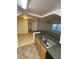 Open kitchen with breakfast bar and ample counter space flows into living area with large windows for natural light at 5968 Westgate Dr # 101, Orlando, FL 32835