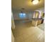 Bright and airy living space with tile floors, lots of natural light, and a seamless transition into the adjacent kitchen at 5968 Westgate Dr # 101, Orlando, FL 32835