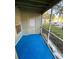 Screened-in patio with blue flooring and outdoor views at 5968 Westgate Dr # 101, Orlando, FL 32835