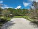 Aerial view of the community sand volleyball court with lush surrounding landscape at 6844 Butterfly Dr, Harmony, FL 34773