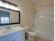 The bathroom features a shower-tub combination and a vanity with framed mirror at 709 Lucaya Loop # 1203, Davenport, FL 33897