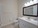 Bathroom with a vanity, framed mirror, tile flooring, and a glass-enclosed shower at 709 Lucaya Loop # 1203, Davenport, FL 33897