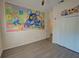Spacious bedroom features wood floors, Mickey Mouse wall decor, and ample closet space at 709 Lucaya Loop # 1203, Davenport, FL 33897