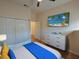 Bright bedroom features a beach scene, hardwood floors, closet and dresser at 709 Lucaya Loop # 1203, Davenport, FL 33897