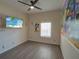 bedroom with a ceiling fan, a window, wood floors and Mickey Mouse wall decor at 709 Lucaya Loop # 1203, Davenport, FL 33897