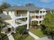 Three-story yellow condo complex showing multiple balconies and manicured landscaping at 709 Lucaya Loop # 1203, Davenport, FL 33897
