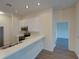 Bright kitchen view features white cabinets, stainless appliances, and wood flooring at 709 Lucaya Loop # 1203, Davenport, FL 33897