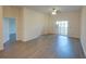 Open-concept living room featuring wood floors, neutral walls, and sliding doors to a balcony at 709 Lucaya Loop # 1203, Davenport, FL 33897