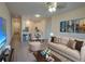 Neutral living room with hardwood floors, stylish furniture, adjacent to dining area and kitchen at 709 Lucaya Loop # 1203, Davenport, FL 33897