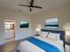 Staged main bedroom featuring hardwood floors, stylish decor, and en-suite bathroom access at 709 Lucaya Loop # 1203, Davenport, FL 33897