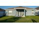Backyard showing a covered patio with ample green space at 751 Jefferson St, Davenport, FL 33837