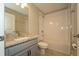 Bathroom featuring a granite countertop, sleek faucet, and tile shower at 751 Jefferson St, Davenport, FL 33837