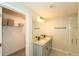 Bathroom featuring a dual granite countertop, sleek faucets, and glass shower at 751 Jefferson St, Davenport, FL 33837