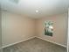 Neutral bedroom with a window bringing in natural light and plush carpet at 751 Jefferson St, Davenport, FL 33837