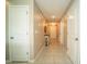 Hallway of the house, with multiple doors and a decorative table at 751 Jefferson St, Davenport, FL 33837