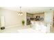 Open kitchen and dining area boasts stainless appliances, granite countertops, and modern pendant lighting at 751 Jefferson St, Davenport, FL 33837