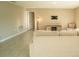 Living room features neutral color palette, modern furnishing and tile flooring at 751 Jefferson St, Davenport, FL 33837