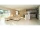 Open concept living room featuring tile floors, neutral color palette, and access to kitchen at 751 Jefferson St, Davenport, FL 33837