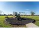 Community playground with climbing structure, swings, and a slide at 751 Jefferson St, Davenport, FL 33837