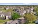 Aerial view of an apartment complex, landscaping and lawns, with parking at 8103 Coconut Palm Way # 205, Kissimmee, FL 34747