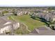 Aerial view of complex showing central green space, walking paths, and proximity to greenbelt at 8103 Coconut Palm Way # 205, Kissimmee, FL 34747