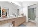 The bathroom has light wood cabinets, double vanity with decorative accents, and a tub with shower in view at 8103 Coconut Palm Way # 205, Kissimmee, FL 34747