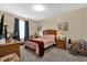 Bedroom with accent paintings on the walls, and lots of light from the window at 8103 Coconut Palm Way # 205, Kissimmee, FL 34747