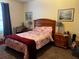 Bedroom with a cozy, warm atmosphere created by soft lighting, carpet and two paintings at 8103 Coconut Palm Way # 205, Kissimmee, FL 34747