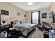Cozy bedroom with a bed, desk, and a chair next to the window at 8103 Coconut Palm Way # 205, Kissimmee, FL 34747