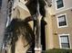 Condo building entrance with stairs and palm tree shadow at 8103 Coconut Palm Way # 205, Kissimmee, FL 34747