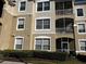 Multi-level condo building with patios and beige stucco exterior at 8103 Coconut Palm Way # 205, Kissimmee, FL 34747