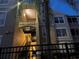 Three-story condo building with palm trees and a black metal fence in the foreground at 8103 Coconut Palm Way # 205, Kissimmee, FL 34747