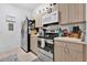 Well-equipped kitchen with stainless steel appliances and light wood cabinets at 8103 Coconut Palm Way # 205, Kissimmee, FL 34747