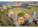 Scenic aerial view of townhomes near a serene lake with lush green spaces at 8507 Waterview Way, Winter Haven, FL 33884